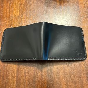 Shell cordovan wallet with yellow buttero interior, Black shinki shell exterior.